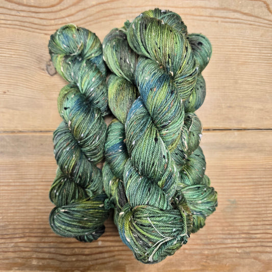 Green skein of yarn on a wooden surface