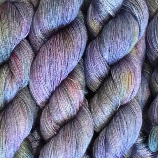 Skeins of yarn in lavender, pink, blue and gold tones